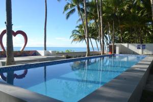 a swimming pool with a view of the ocean at Maject View Events & Resort in Siaton