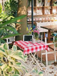 a table with a laptop on it in a garden at 1.Hôme in Hanoi