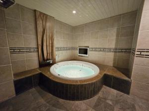 a bathroom with a large tub in a room at HOTEL SULATA Sapporo (Adult Only) in Sapporo +67 photos