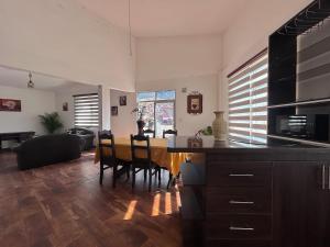a kitchen and dining room with a table and chairs at Corta Estadía Sucre in Sucre