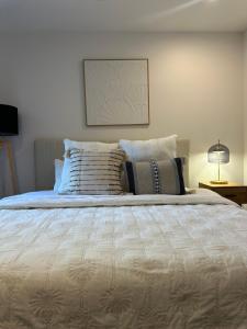 une chambre avec un grand lit avec des oreillers dessus dans l'établissement Avalon Maroochydore, à Maroochydore 8 autres photos