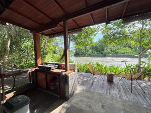 a screened in porch with a view of a river at Balian River Hut in Balian