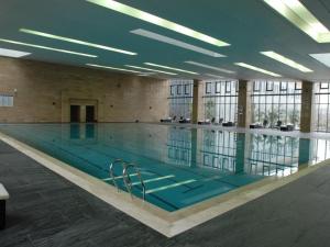 a large swimming pool in a large building at Sichuan Tennis International Hotel Main Building in Chengdu