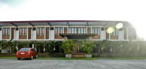 a red car parked in front of a building at Mango Valley Hotel in Olongapo