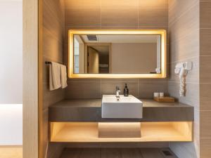 a bathroom with a sink and a mirror at JI Hotel Chengdu Tianfu Square Renmin Middle Road in Chengdu +22 photos