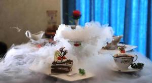 a table topped with a piece of cake and a cup of tea at James Joyce Coffetel Golmud Huaxing Plaza Branch in Golmud