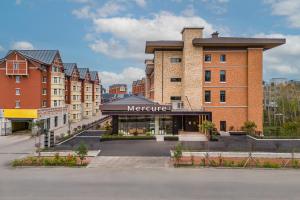 a large brick building with a meyrine sign on it at 长白山 Mercure Hotel in Baomacheng