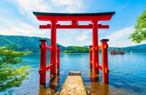 a red torii gate in the middle of a lake at Your Bedroom Hakone in Odawara