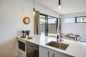 a kitchen with a sink and a counter top at Quiet on Cassin - Taradale in Napier