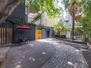 a patio with a table and a red umbrella at JI Hotel Chengdu Tianfu Square Renmin Middle Road in Chengdu