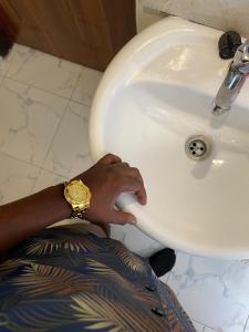 ナイロビにあるHays Suites Hotelの洗面台の横に座っている人 +20枚の写真