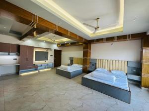 a room with two beds and a flat screen tv at Iconic Suites in Chittagong