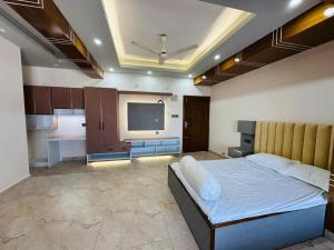 a bedroom with a bed and a flat screen tv at Iconic Suites in Chittagong