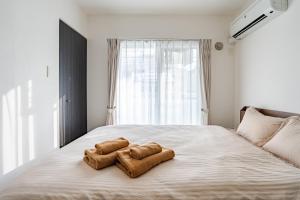 Ένα ή περισσότερα κρεβάτια σε δωμάτιο στο BN Nakajima Park