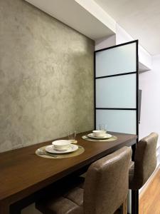 Un comedor con mesa y sillas de madera. en The UrbanNest, en Piapi 4 fotos más