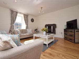 a living room with a couch and a tv at 3 Bed in Belford oc-76672 in Belford