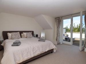 a bedroom with a large bed and a large window at 3 Bed in Belford oc-76672 in Belford