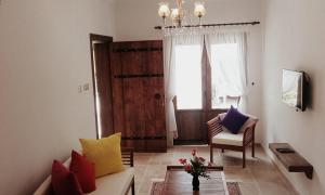a living room with a couch and a chair at Malia Apartment in Famagusta