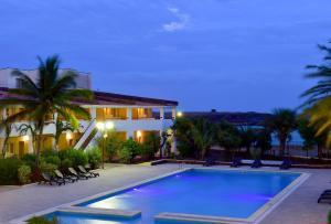 a large swimming pool in front of a house at Pestana Tropico Ocean & City Hotel in Praia