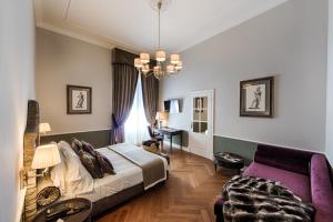 Postel nebo postele na pokoji v ubytování Palazzo Roselli Cecconi