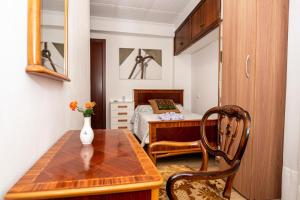 una piccola camera con letto e tavolo in legno di CASA TONIO a Banyeres de Mariola