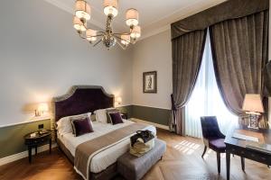 Postel nebo postele na pokoji v ubytování Palazzo Roselli Cecconi