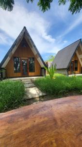 a house with a gambrel roof at Zalfa Homestay in Taliwang