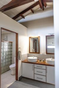 a bathroom with two sinks and a toilet at Whispering Palms - Absolute Beachfront Villas in Port Vila +34 photos