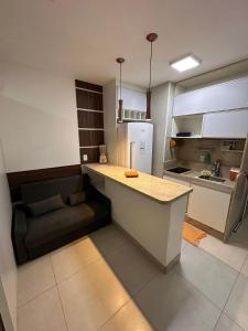 a kitchen with a counter and a couch in it at Jubiabá - 1110 A - Net 200 MB in Ilhéus +16 photos