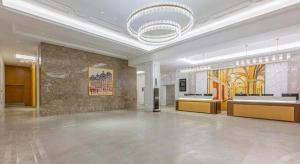 a large lobby with a chandelier in a building at Vienna Hotel Qinghai Dachaidan in Da Qaidam