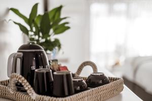 a tray with affeepot and cups on a table at The Esperance Accommodation in Esperance