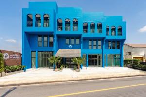 a blue building on the side of a street at Blu Monkey Boutique Naiharn Beach in Nai Harn Beach