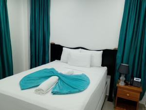 Ένα ή περισσότερα κρεβάτια σε δωμάτιο στο Hotel Mendoza Inn