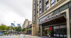 a city street with a building and a stop sign at Borrman Hotel Zhangzhou Baolong Plaza in Zhangzhou