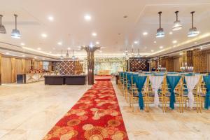a banquet hall with tables and chairs and a bar at Treebo KGF Villa with Swimming Pool in Prayagraj