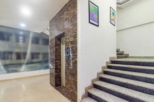 a staircase in a building with a stone wall at Treebo KGF Villa with Swimming Pool in Prayagraj