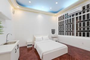 ホーチミン・シティにあるH2T Hotel VanHanhSmallの白い部屋(ベッド1台、シンク付)