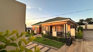 a house with a fence in front of it at Beauty Blender Homes - The Executive House in Lilongwe