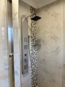a shower with a glass door in a bathroom at Beauty Blender Homes - The Executive House in Lilongwe +4 photos