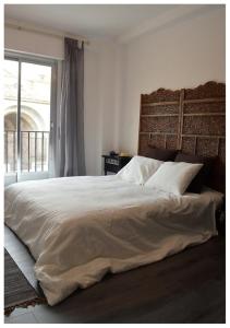 a bedroom with a large bed and a window at Colegiata Home in Talavera de la Reina