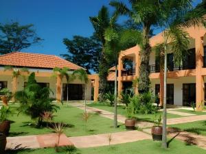an exterior view of a building with palm trees at Khaolak Palm Hill Resort in Khao Lak