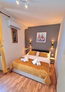 a bedroom with a large bed with towels on it at INCHY ACCOMMODATION - in the center of Diocletian's Palace in Split