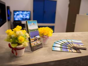 a table with flowers and cards on a table at Chantara Valley Resort in Ban Sap Bon