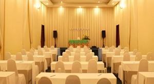 a conference room with white tables and chairs and a podium at The Forest Home Resort in Ban Dong +160 photos
