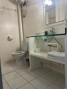 a bathroom with a toilet and a sink and a mirror at Les Trois Ilets Location Studio Face a la Mer in Les Trois-Îlets