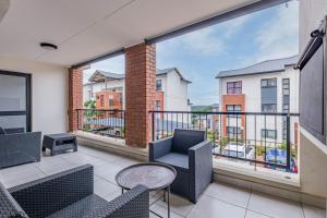 a balcony with chairs and a table with a view at 356 Ballito Hills in Ballito