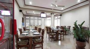 a dining room with tables and chairs in a restaurant at Hotel Griyadi Kusuma Sahid in Solo