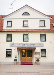 a building with the front entrance to the world grant kvp at Hotel Garni Krone in Senden