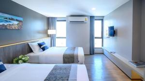 a hotel room with two beds and a tv at IWISH Hotel Bangkok in Ban Bang Khen (1) +192 photos