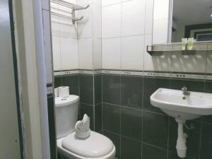 a bathroom with a toilet and a sink at Swing & Pillows - Sentul in Kuala Lumpur